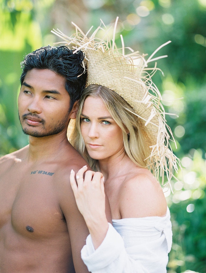 Couple embracing and smiling during a Bali engagement session, photographed with a relaxed and natural candid style