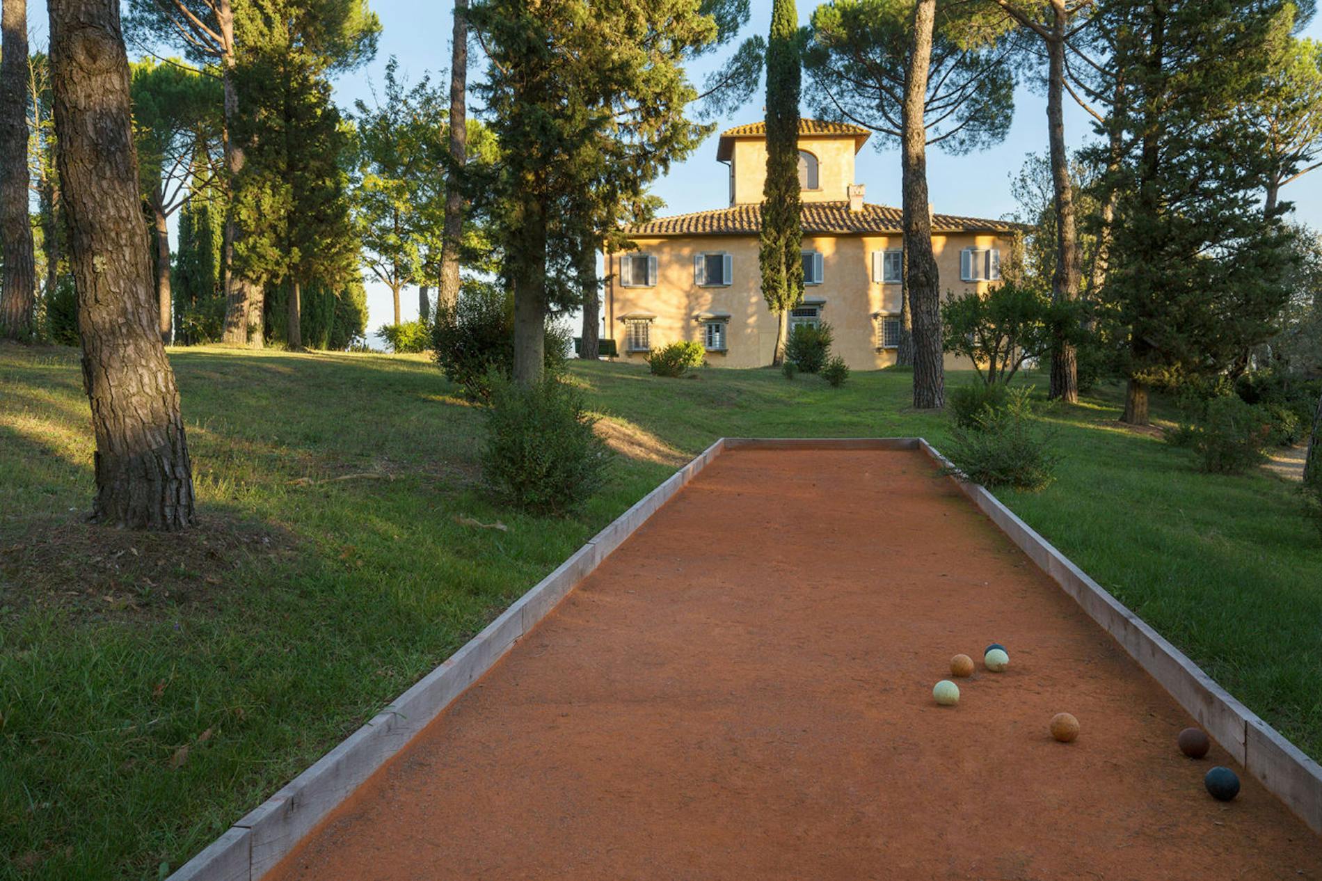 A pristine red clay court for bowls near Villa La Tavernaccia