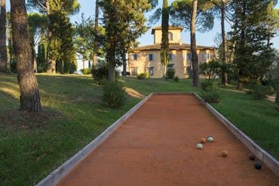 A pristine red clay court for bowls near Villa La Tavernaccia