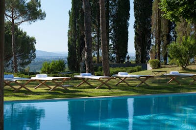 The heated swimming pool in the garden of Villa La Tavernaccia, with italian-designed outdoor seatings.