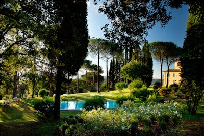 The heated swimming pool in Villa La Tavernaccia is surrounded by a private garden