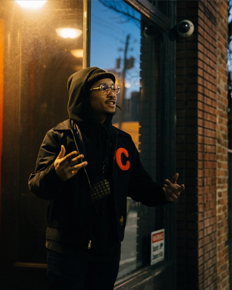 A man standing in front of a window.