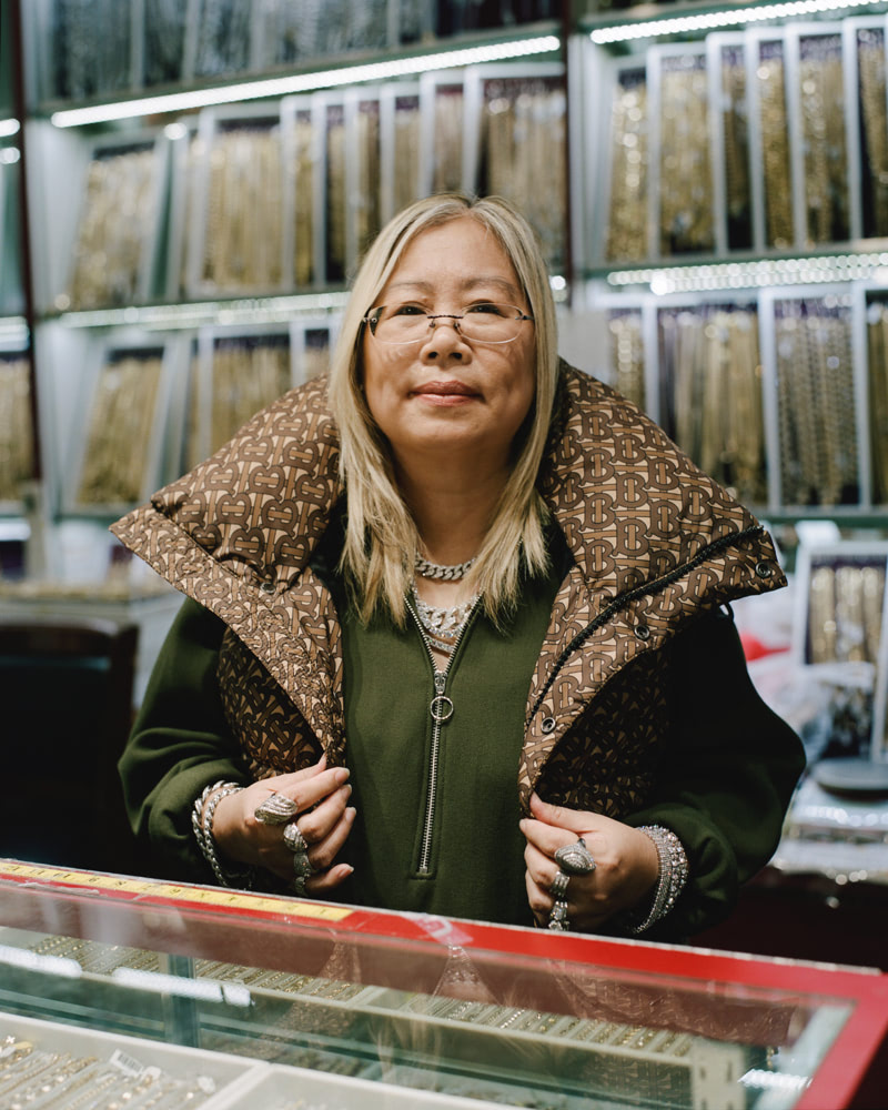 A woman standing in her jewelry shop.