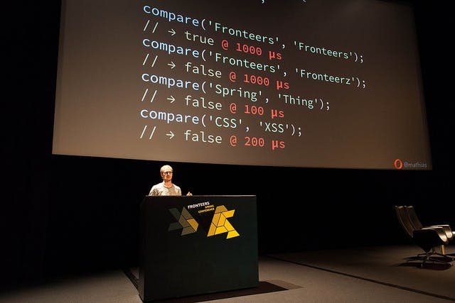 Man standing in front of a screen with code on it