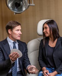Dr. Fenner with patient discussing breast augmentation