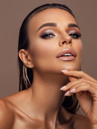 Headshot of a woman with her hand against her chin