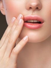 Woman with fingers to her lips