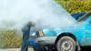 Man looking at a smoking engine