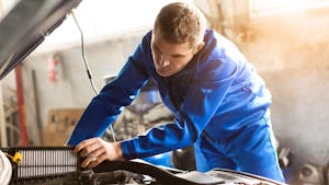 Mechanic working under a car