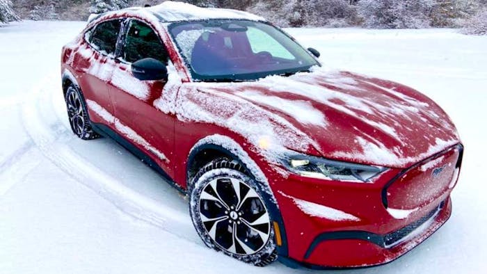Red Ford Mustang covered in snow