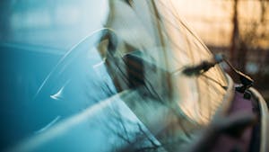 Close up image of a windshield and steering wheel