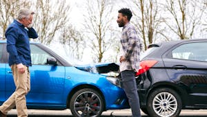 Two cars collided with the owners beside it