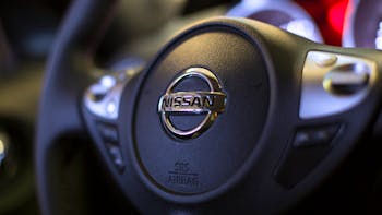 Close up image of steering wheel of a Nissan car