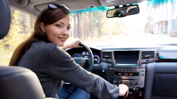 Young woman inside a new car
