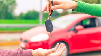 car key being handed to new owner