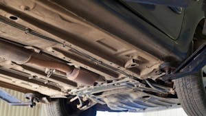 Car lifted on auto hoist at service station