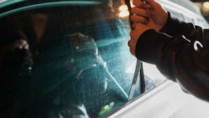 Carjacker unlocking vehicle