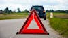 Red warning triangle with a broken down car