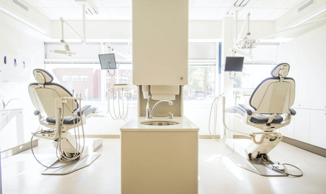 dentist's office with two dental chairs facing the window