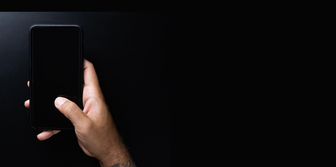 a man's hand holding a phone