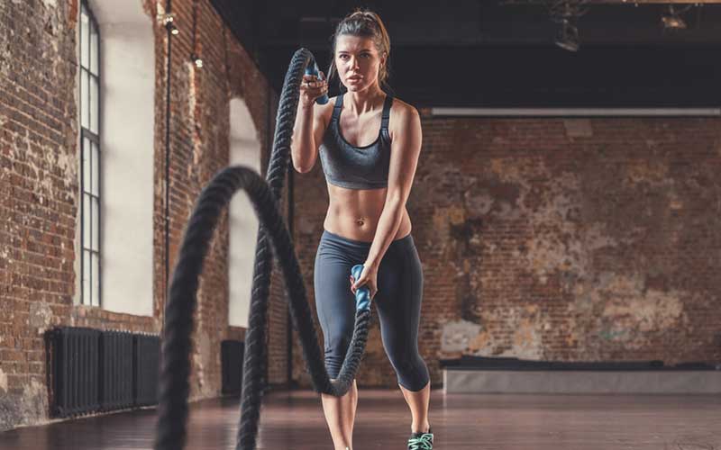 woman exercising with ropes