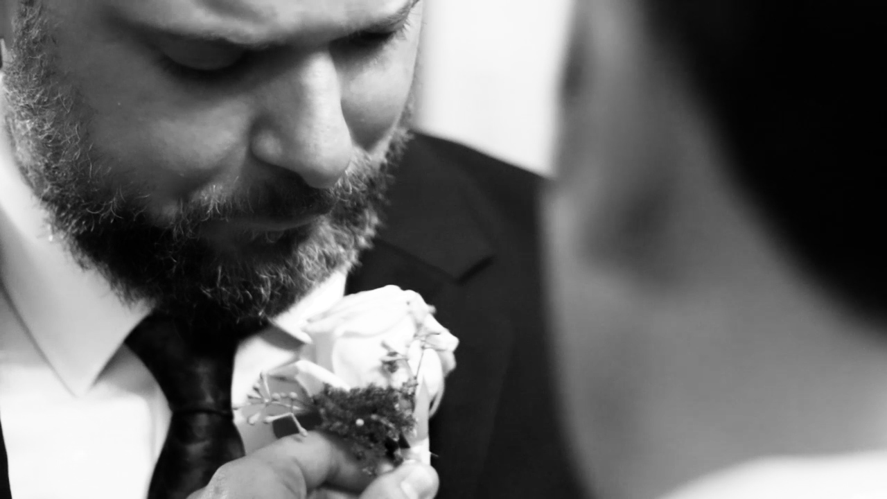 Henry getting his boutonniere on his wedding day