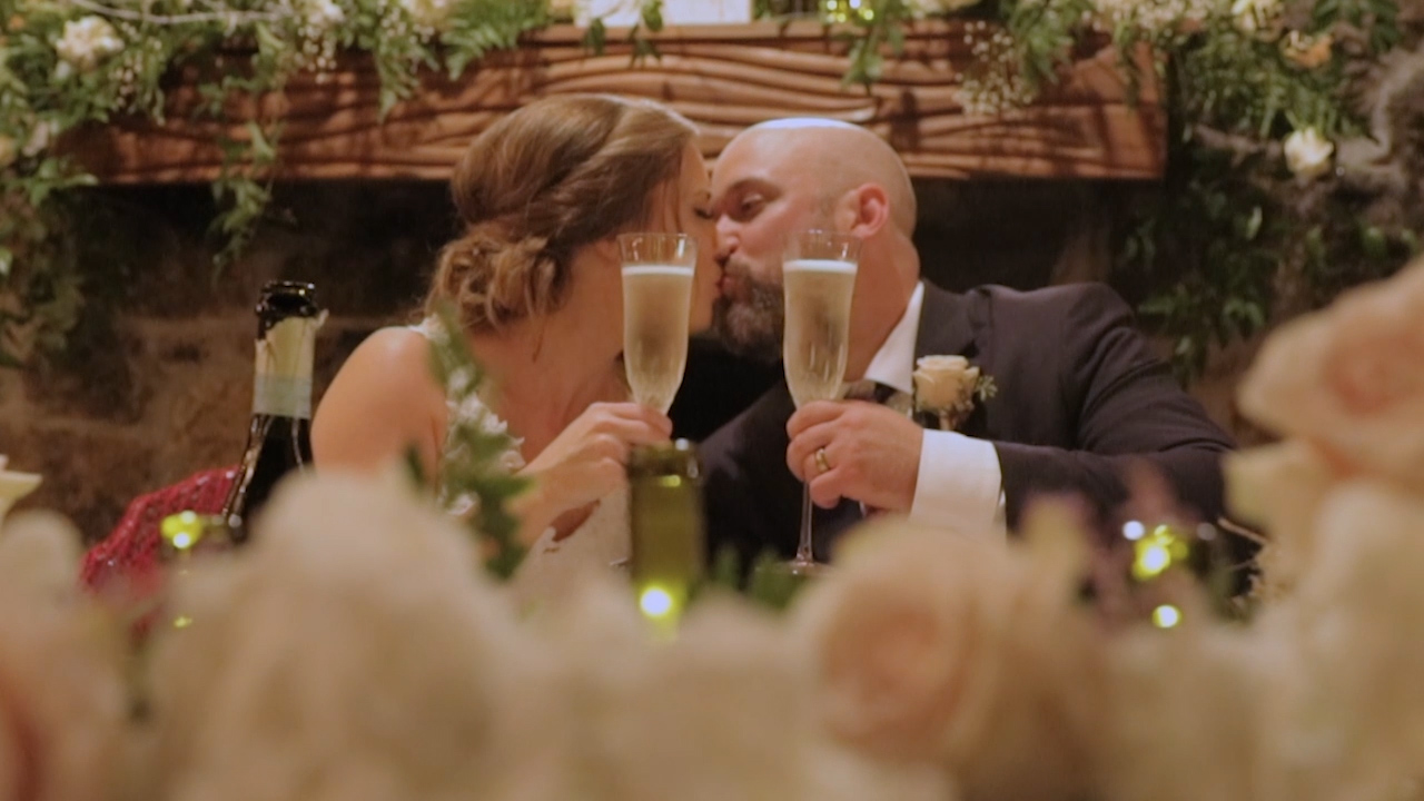 Henry and Nicole toast during their wedding reception at Stone Chapel in Fayetteville