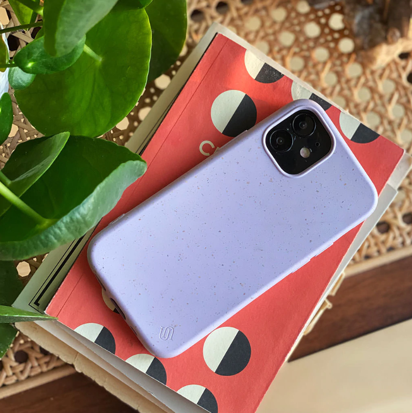 an iphone in a purple protective case on a table