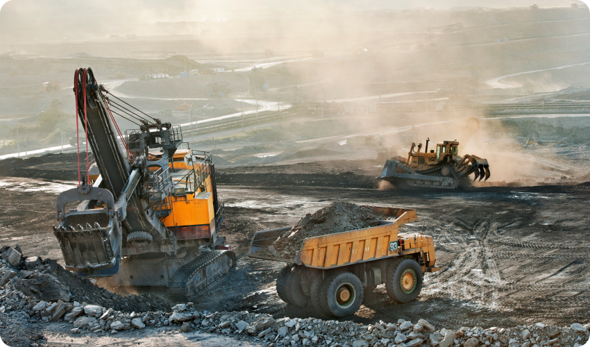Three yellow excavators being used for mining materials