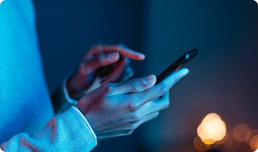 Side view of man using a smartphone