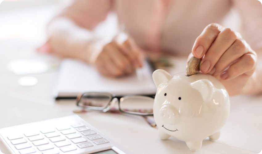 Woman putting money into a piggy bank