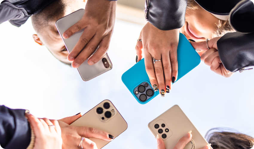 group of people holding Apple and Android smartphones