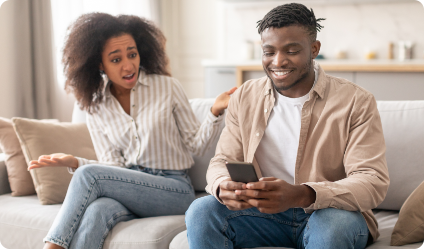 Woman unhappy with man as he ignores her in favour of his mobile phone