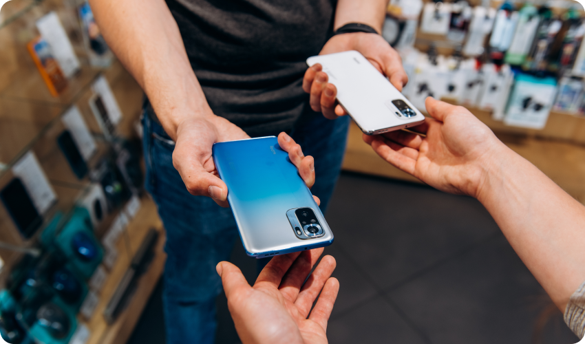 Person handing in their old phone in preparation for a phone upgrade