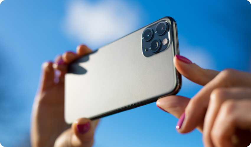 Woman holding phone to take picture