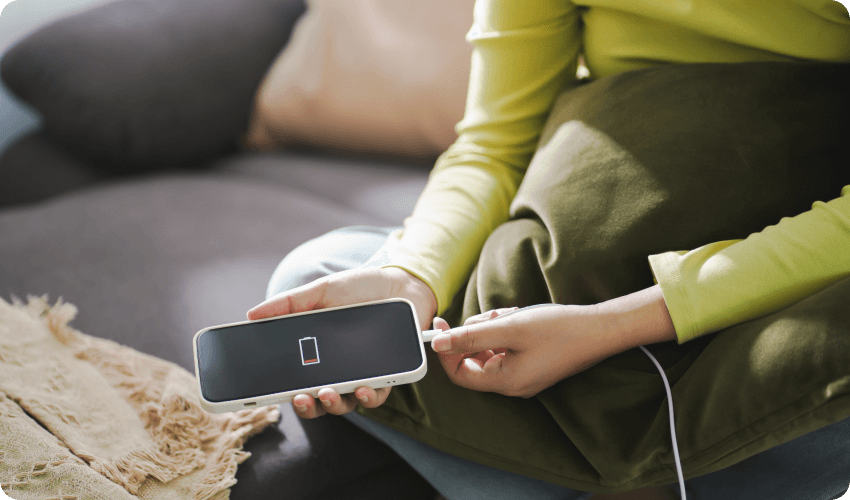 Woman putting her mobile phone on charge