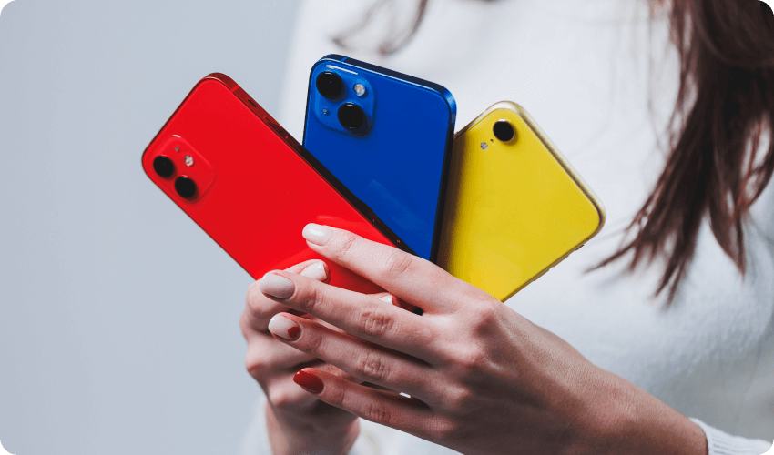 Woman holding colourful new smartphones