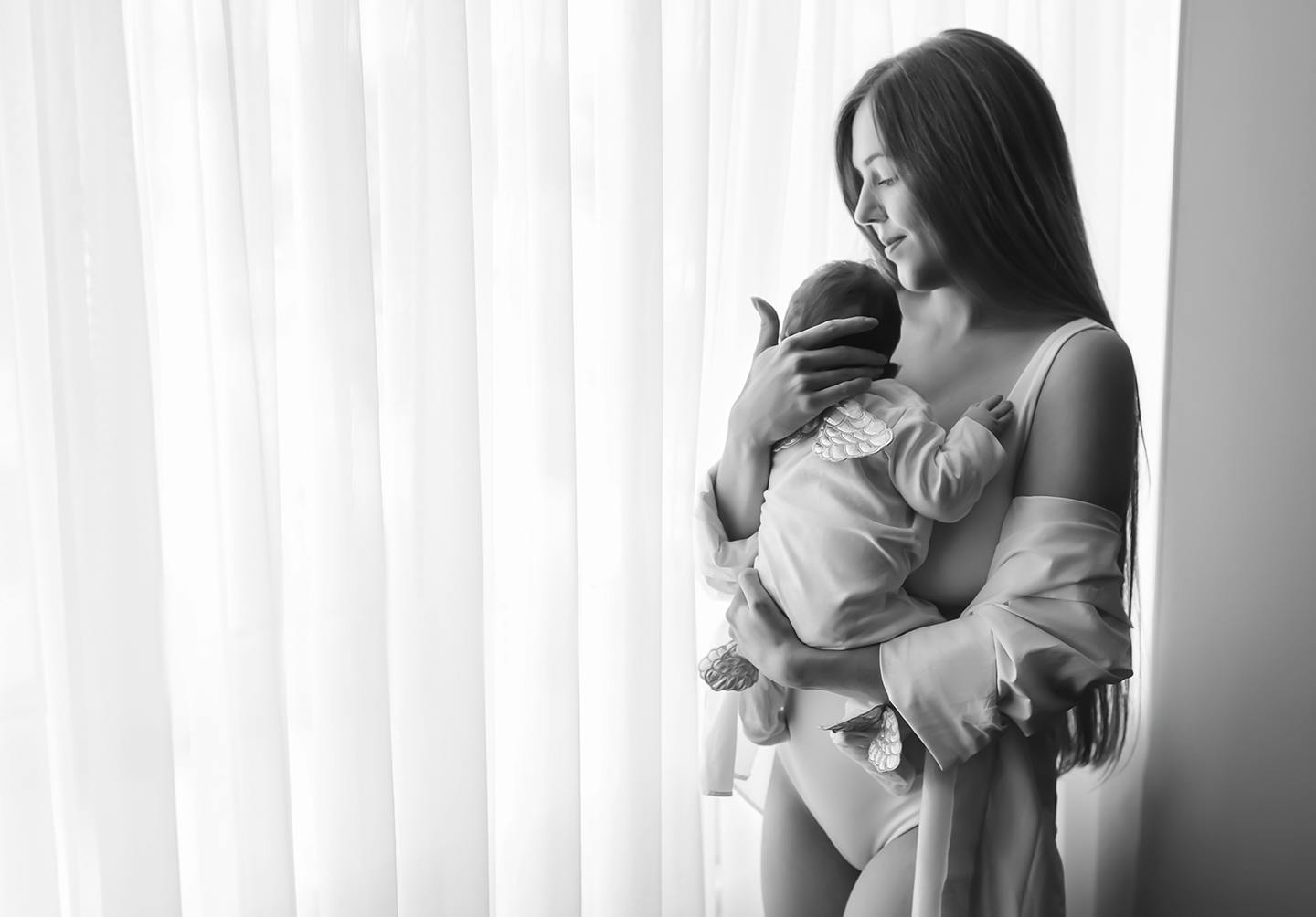 Black and white photo of mother holding new born child