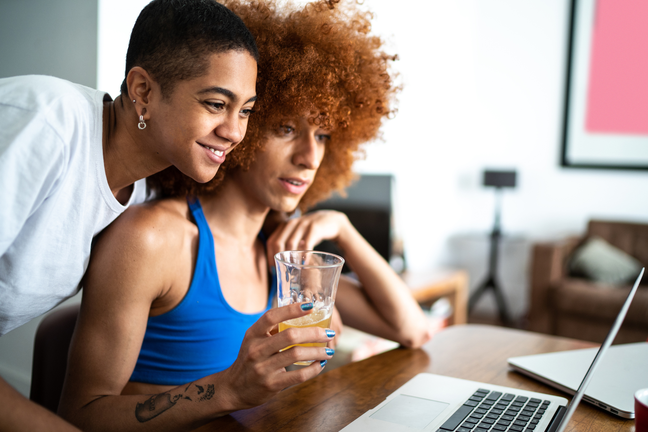 two people looking at a laptop