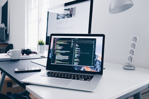 laptop with code on desk