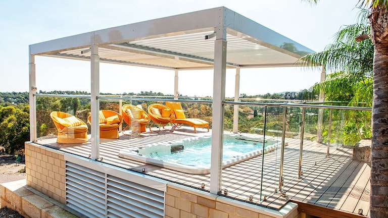 in-ground swim spa in deck with pergola