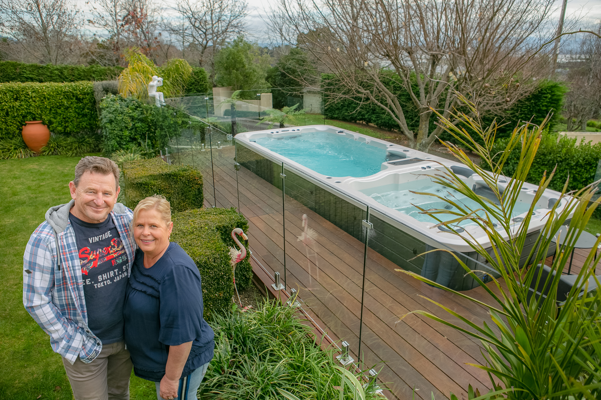 couple beside a swim spa