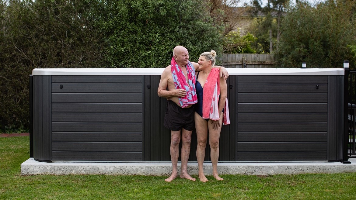 Swim spa on a concrete pad in backyard