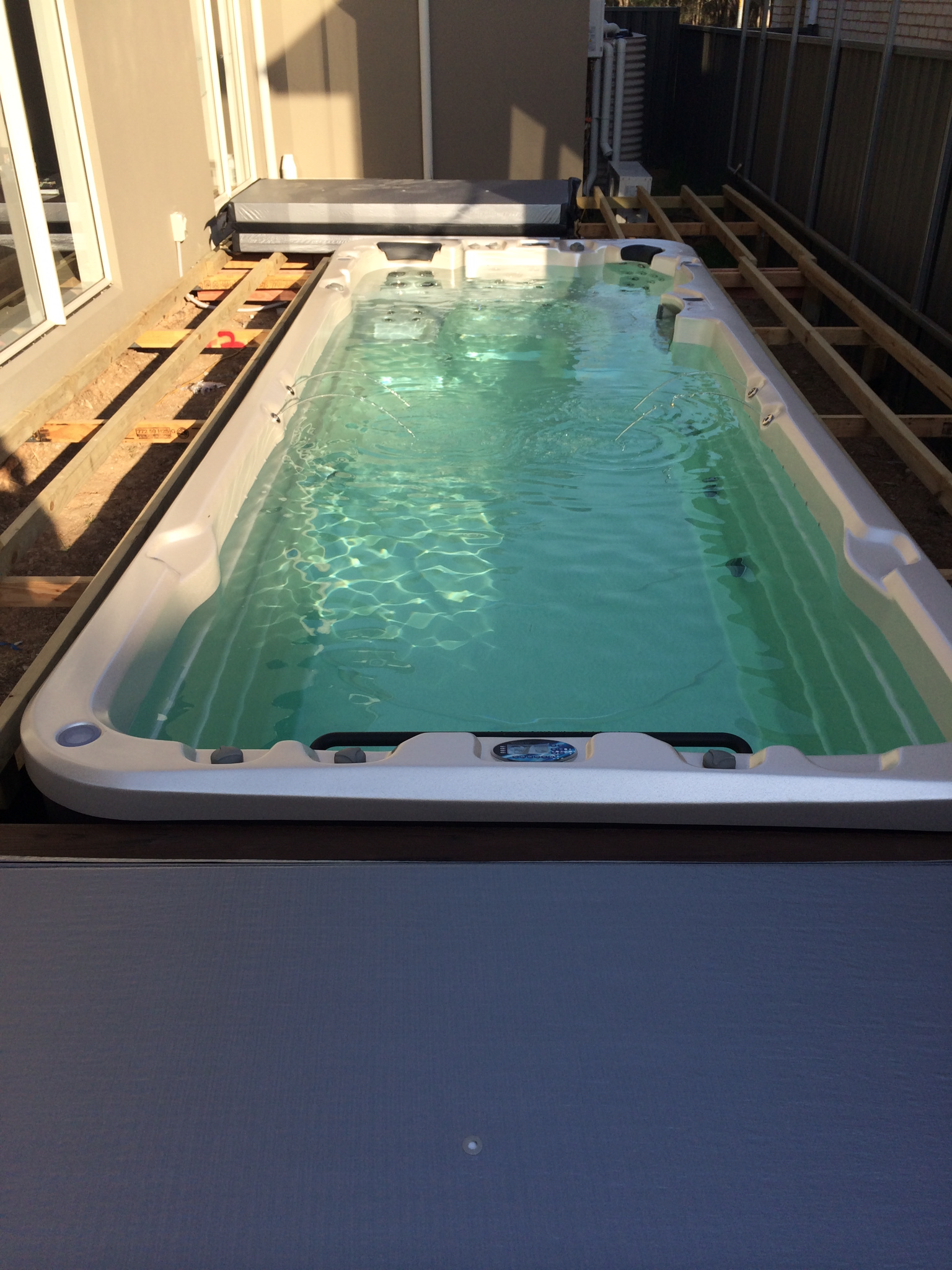 swim spa pool with decking in a pit