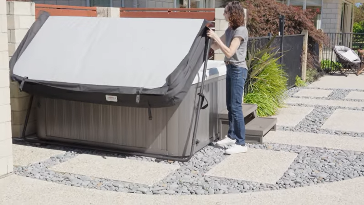woman lifting a jacuzzi spa cover