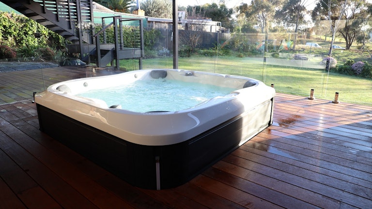 Jacuzzi® J-345™ installed in a deck with backyard