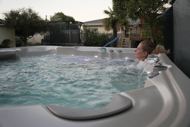 Woman enjoying Nitro spa pool in summer