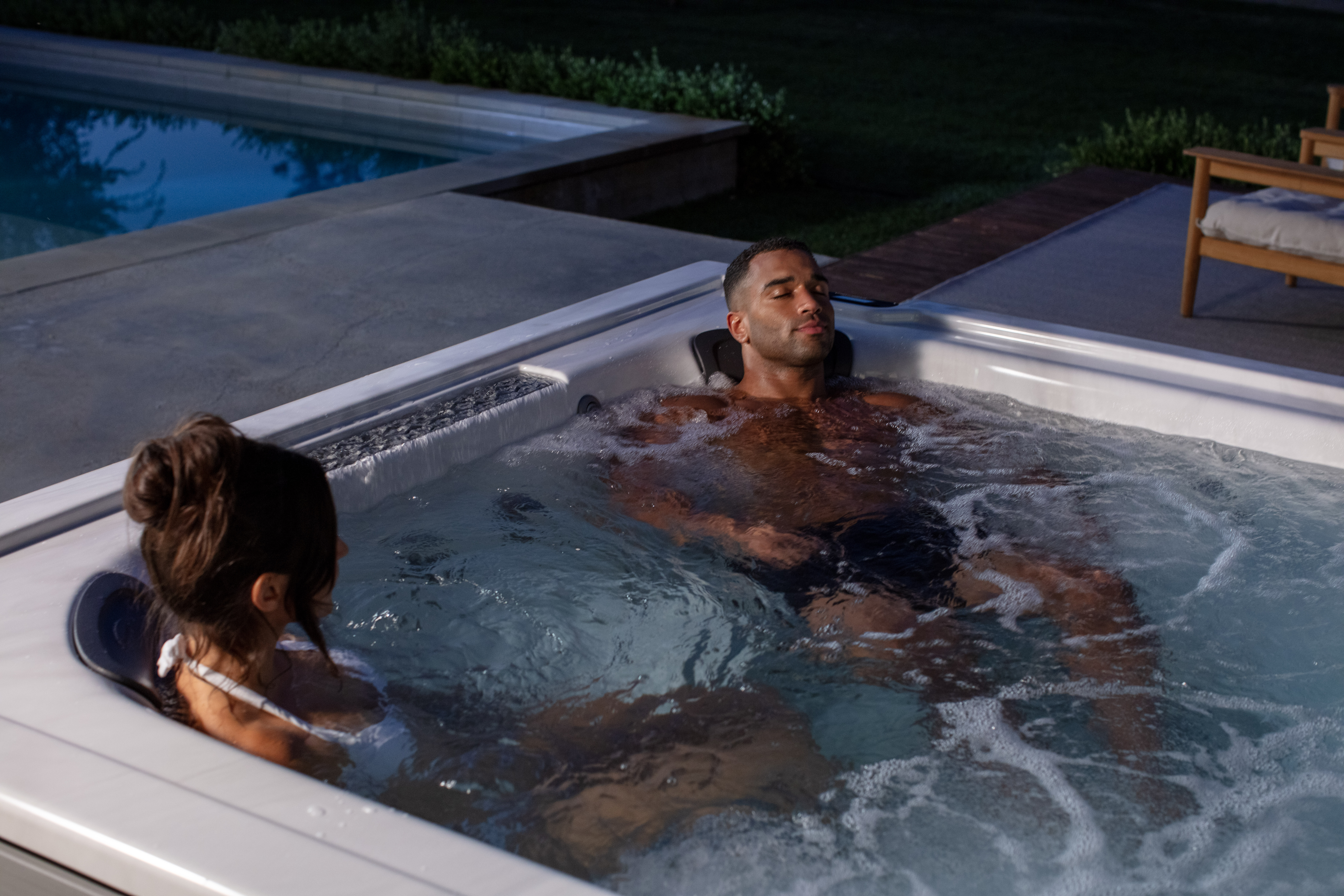 Couple relaxing on a J-LXL hot tub