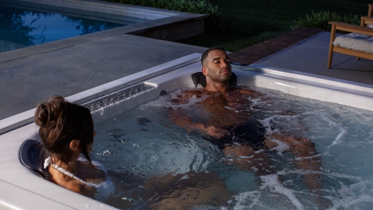 Couple relaxing on a J-LXL hot tub
