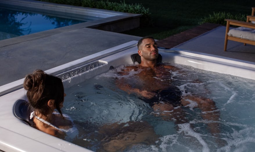 Couple relaxing on a J-LXL hot tub